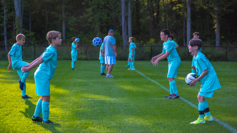 A young soccer team playing together.